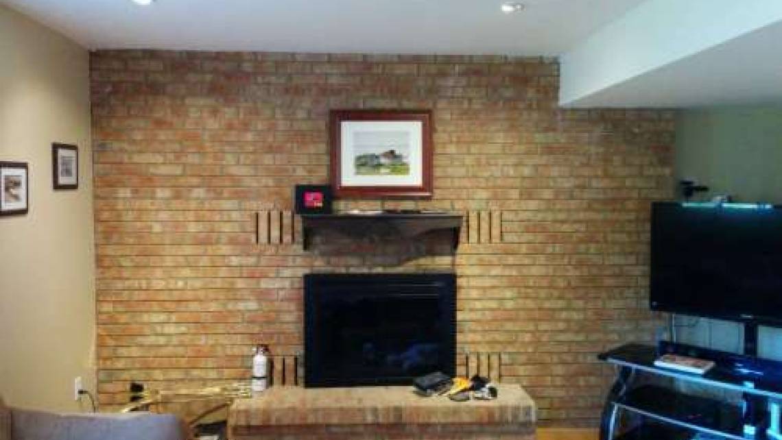 Whitewash a brick fireplace wall